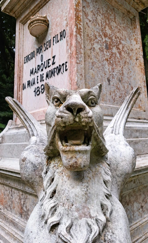 a small dragon statue with a marker on it