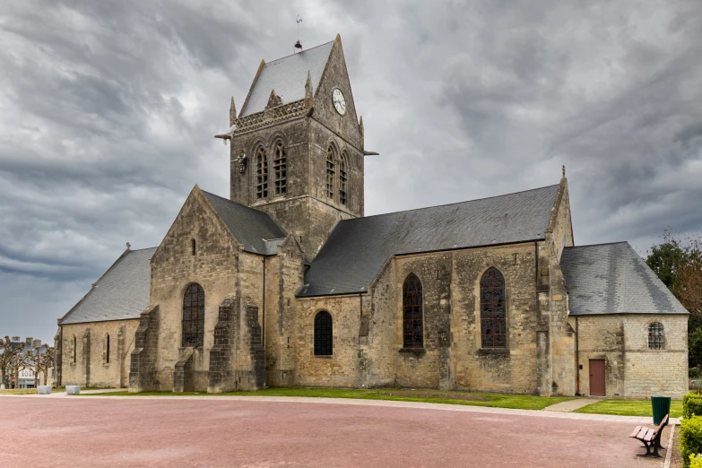 the outside of an old cathedral with cloudy skies