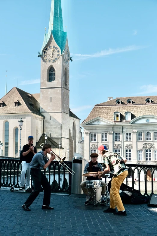 some people playing instruments while standing next to some buildings