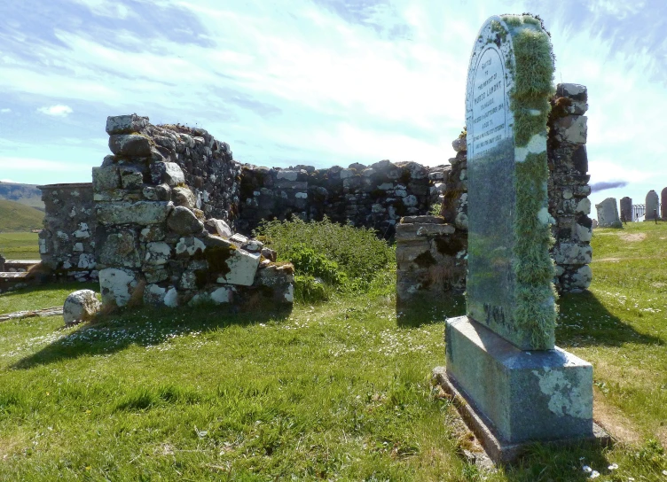 some very old stone buildings in a field