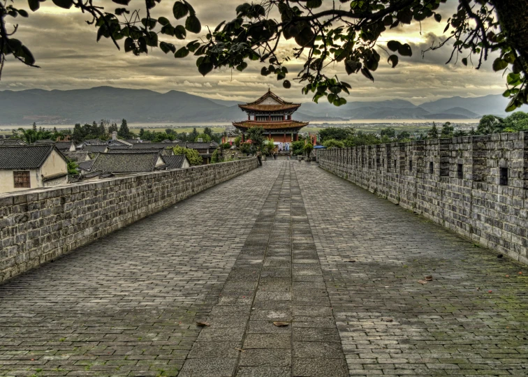 the path in the area of this historic city has brick walls and cobblestones, as well as the walkway to a pagoda