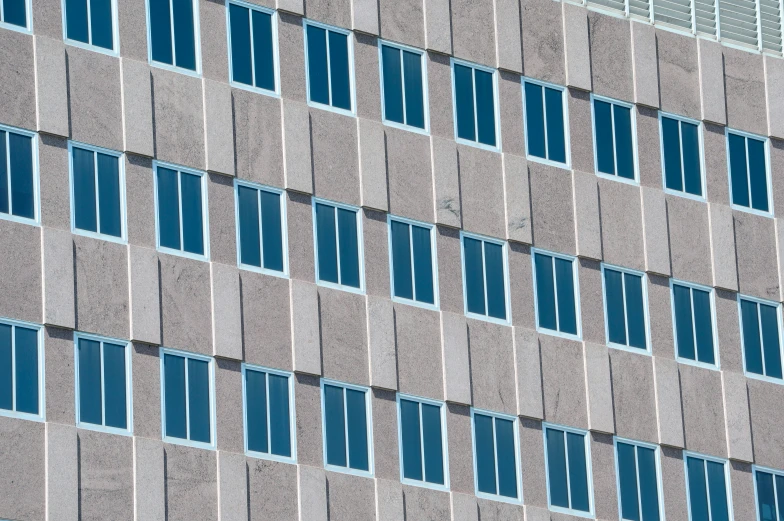 the side of a building has a blue window panes