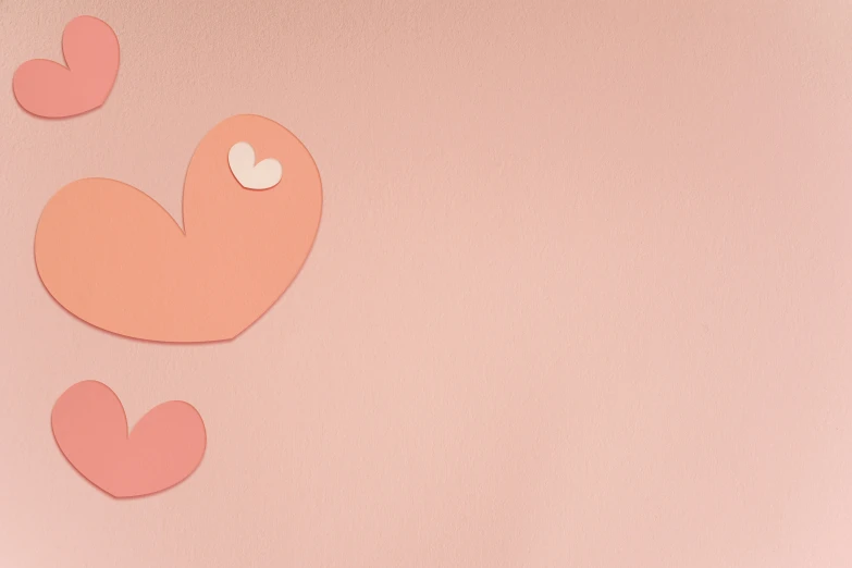 paper birds with hearts hanging from them on a pink background