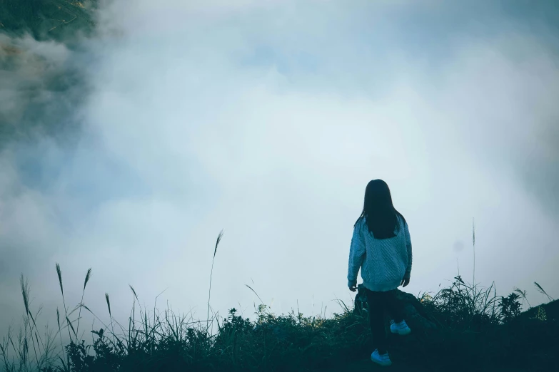 the woman is staring at the clouds above