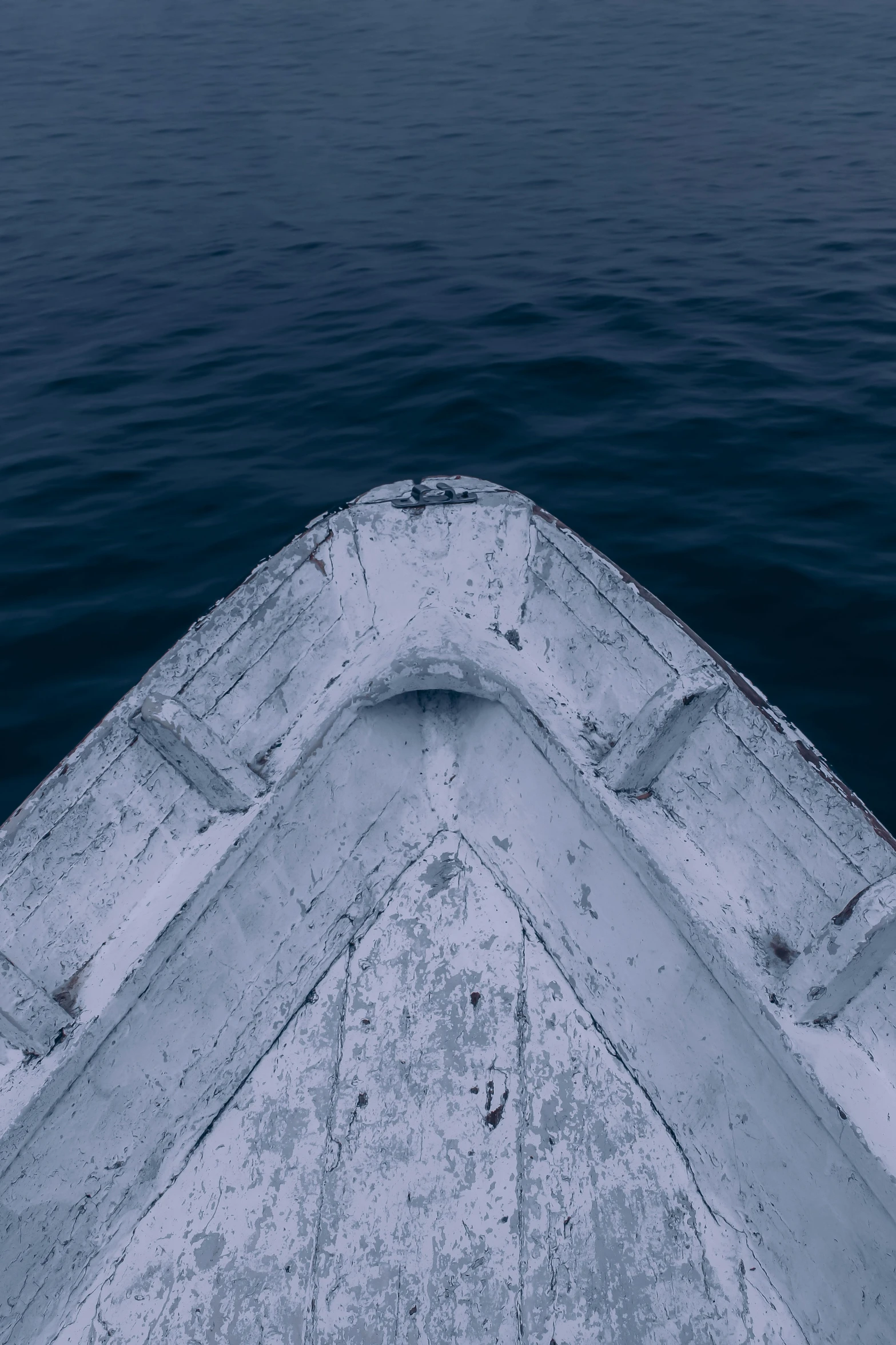 the bow end of a boat with water in the background