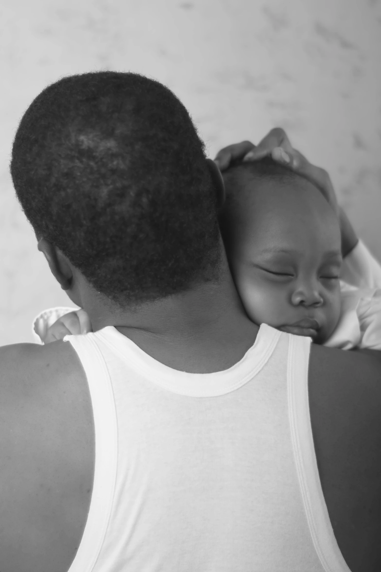 a man holding his child in his arms