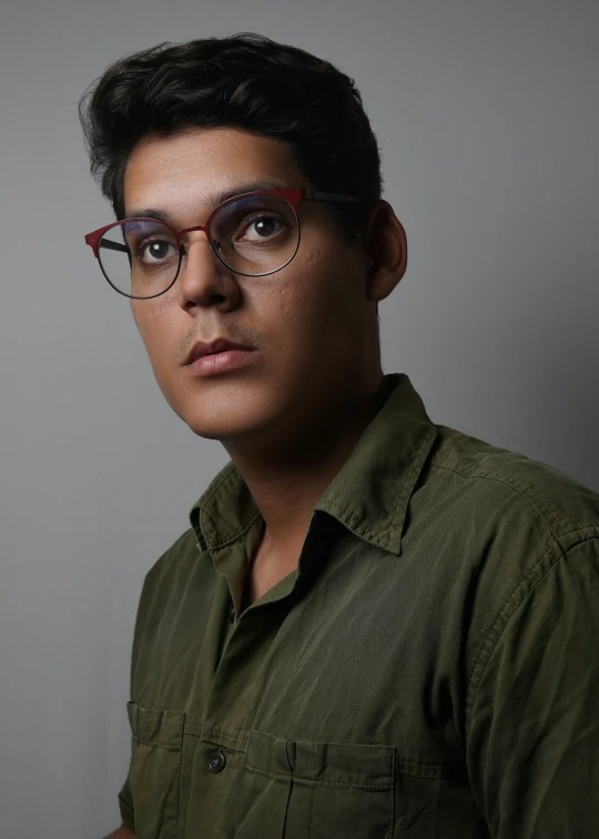 a young man with black hair and glasses