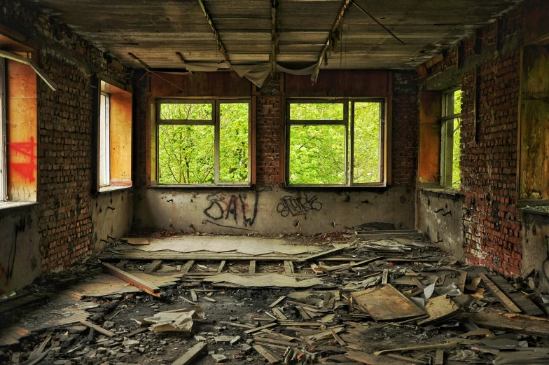 an old run down, abandoned building with only windows and graffiti on the walls