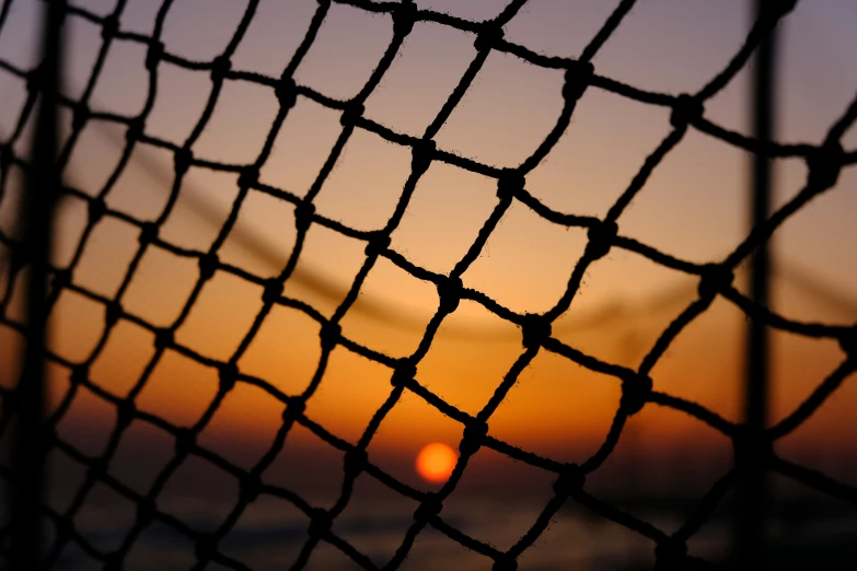 a closeup of a net in the evening