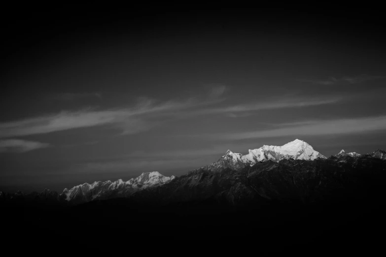 some snow mountains under a dark sky