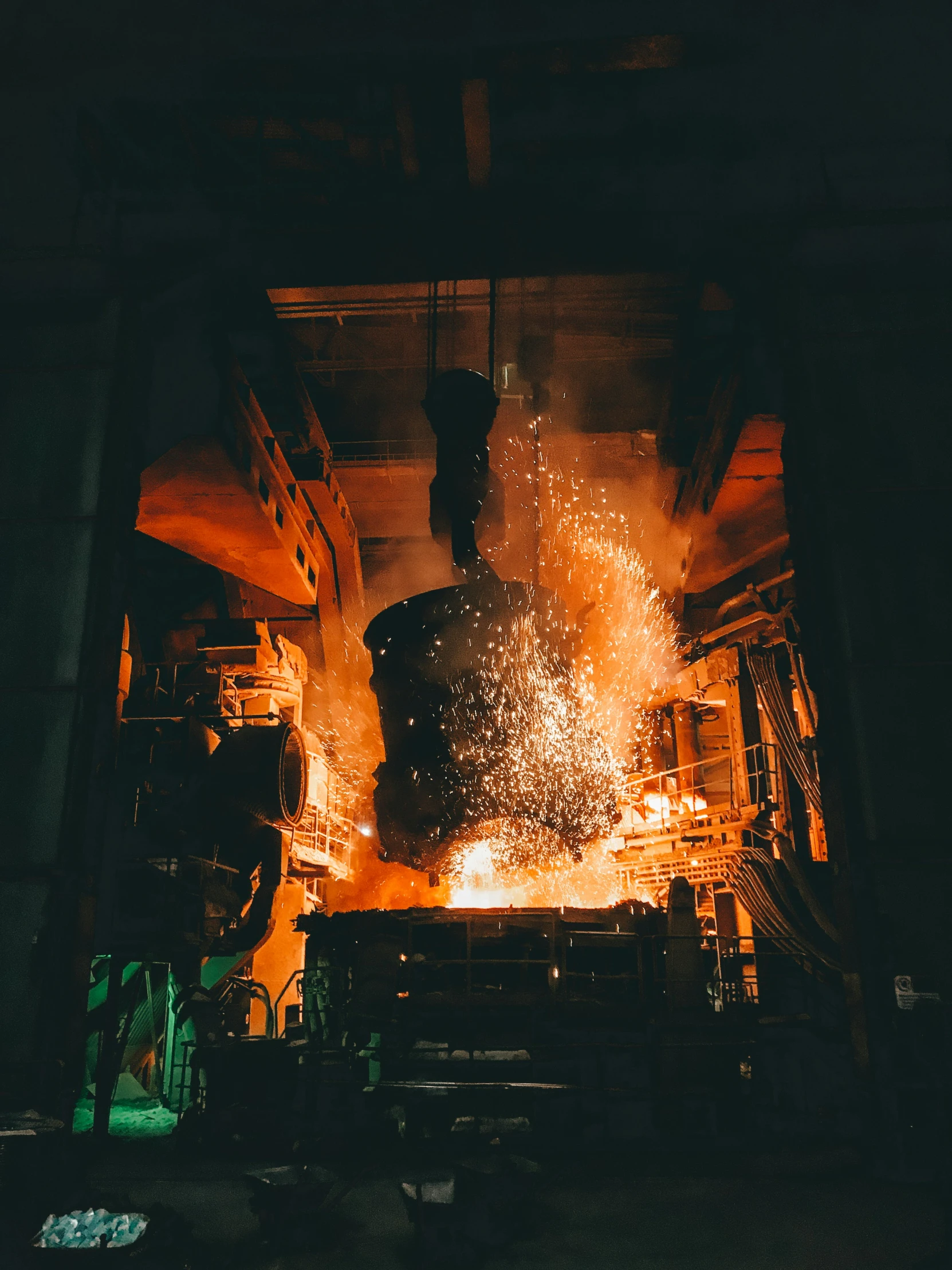 a man standing in front of a metal oven