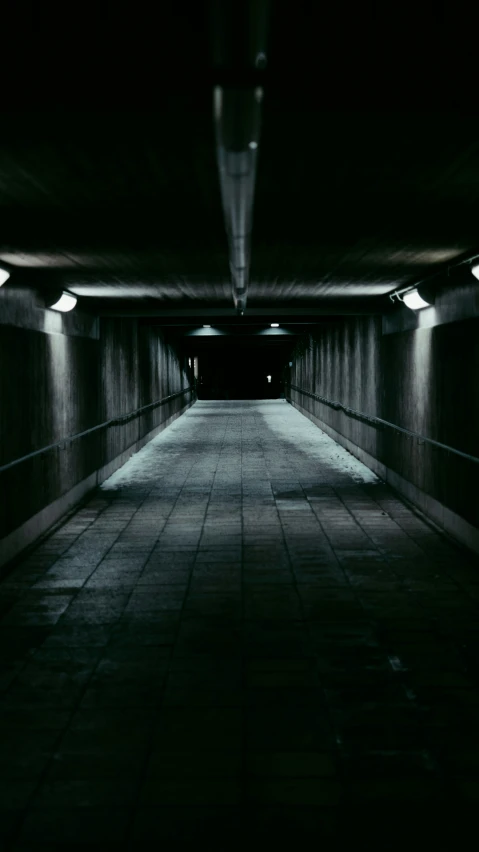 a very dark looking tunnel with some lights