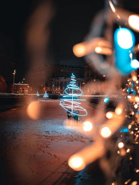 a blurry image of a lit christmas tree outside