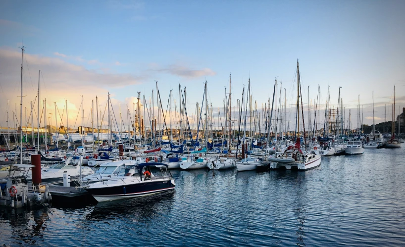 many small boats are docked at the pier