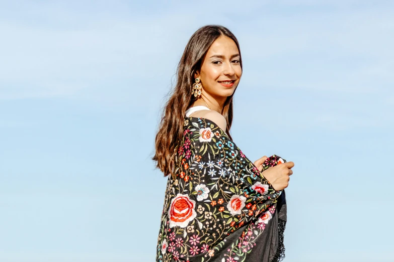 a beautiful woman standing on top of a beach