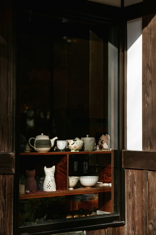 a window on a building that has some pottery in it