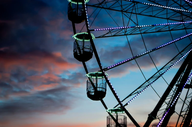 a ferris wheel that is next to some lights