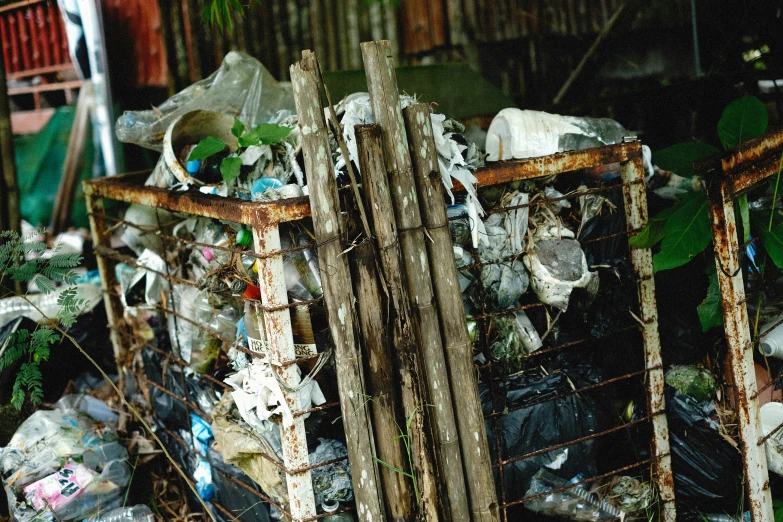 a basket full of garbage sitting on the side of a building