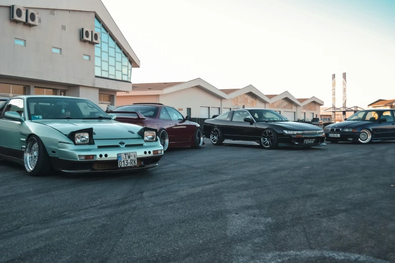 four car parked together in front of a building