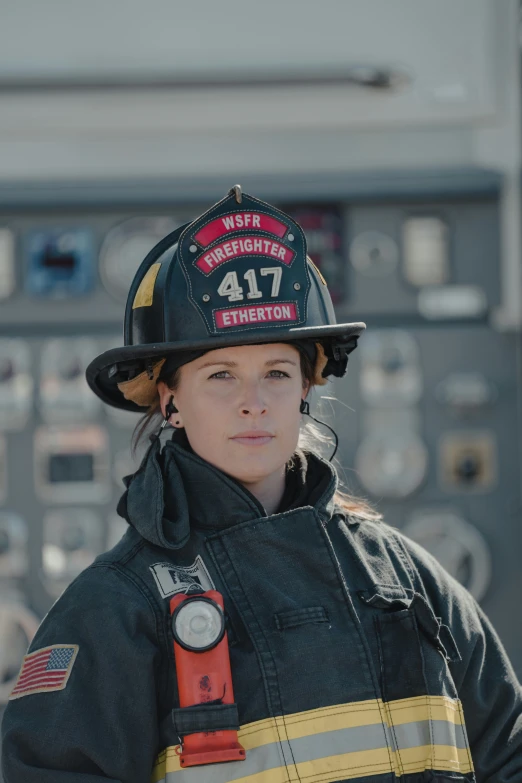 the young woman is wearing her firefighter uniform