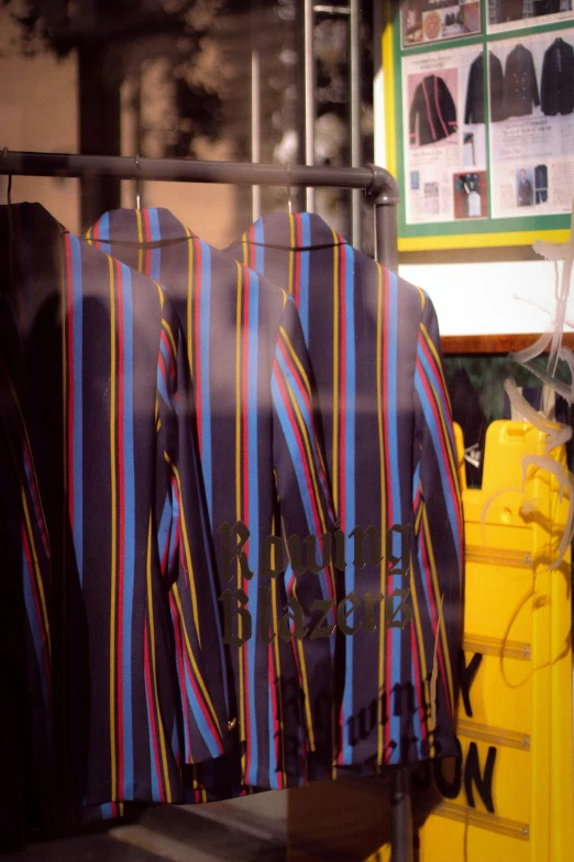 a line of colorful tie shirts hanging on the rack