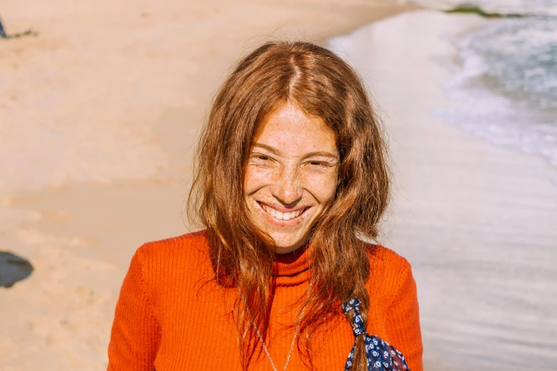 a woman on the beach with long hair