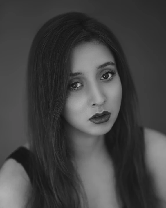 a girl poses in a black and white portrait