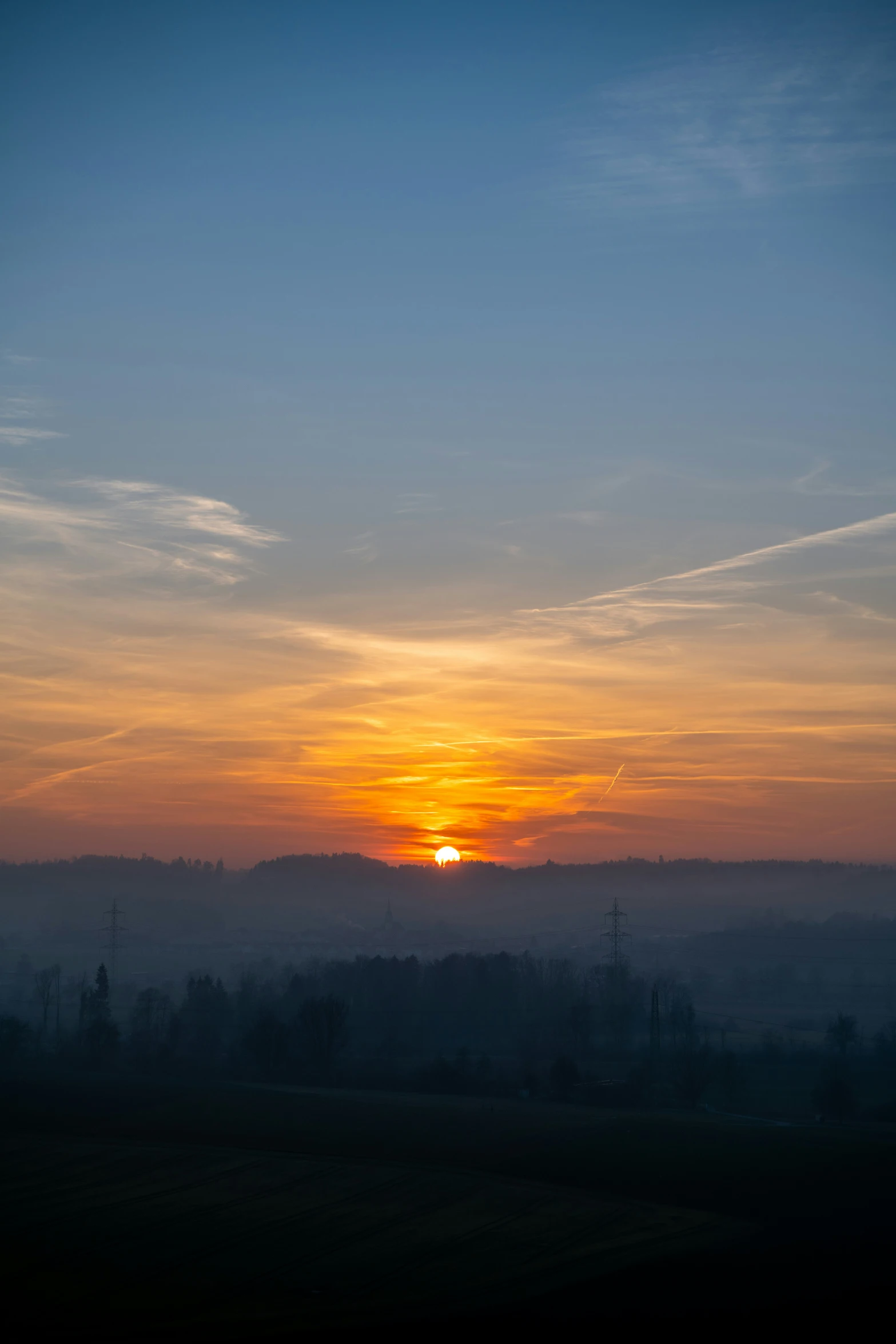 a sunset view over the mountains and countryside