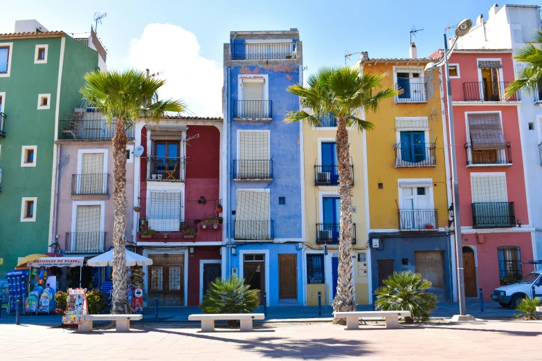 brightly painted buildings line a small plaza in a downtown area