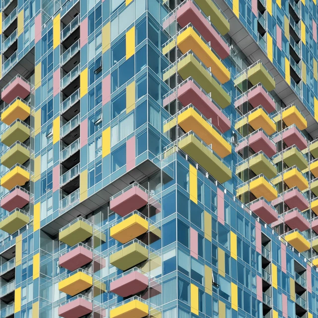 a tall building with balconies and windows painted in different colors