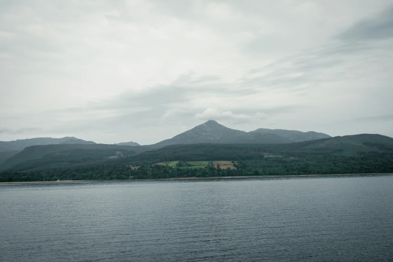 the water with mountain range in background