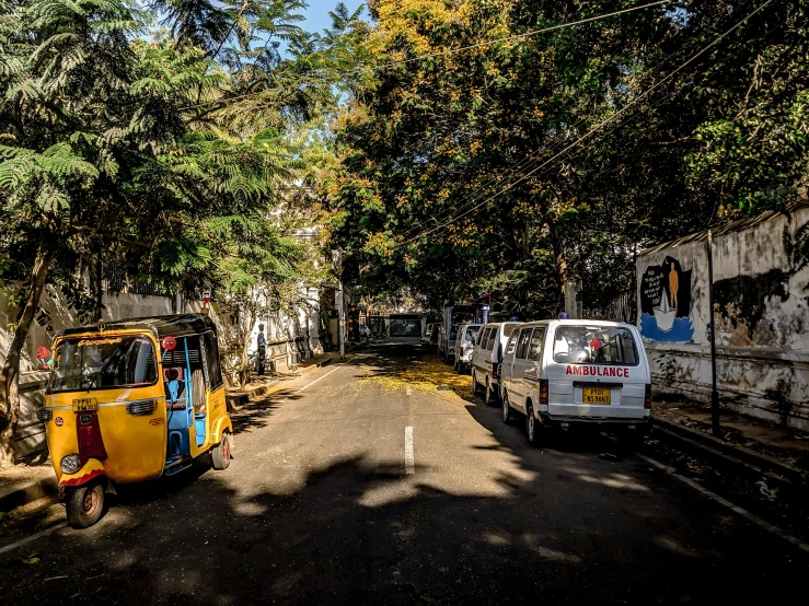 the vehicles and the bicycles are parked on the road