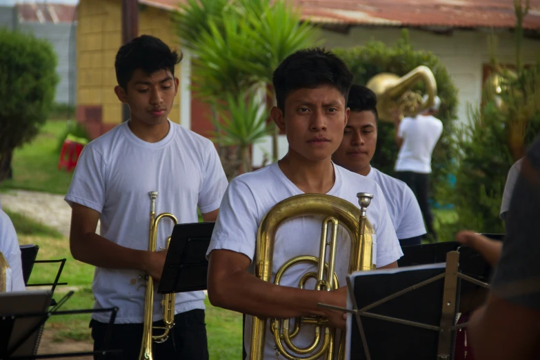 some guys are playing trombone in the street