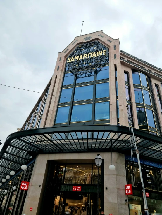 a tall glass building with a sign that reads, sanwapulane