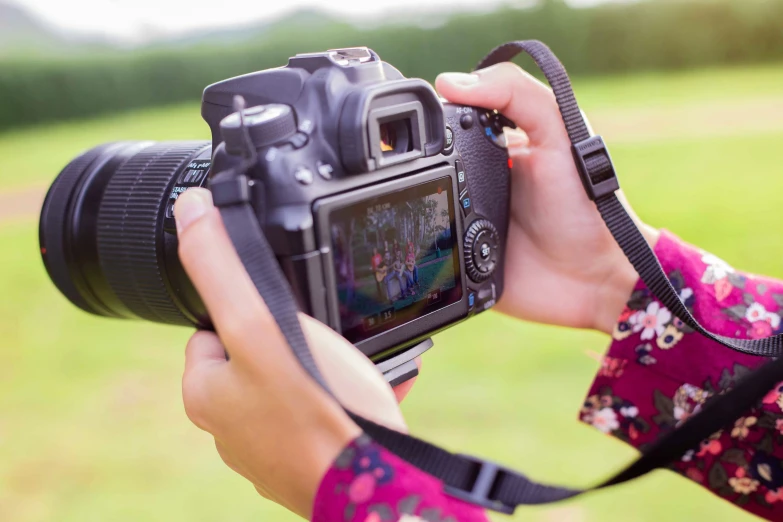 the woman is taking pos with her camera