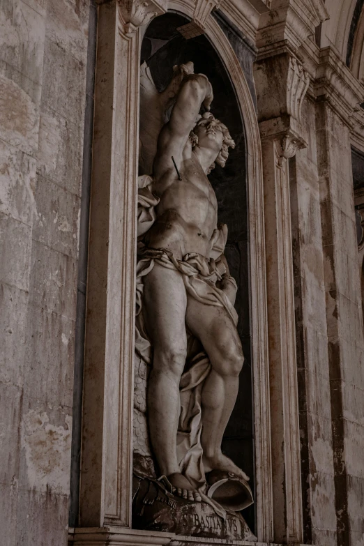 statue of jesus with hand on his head above a doorway