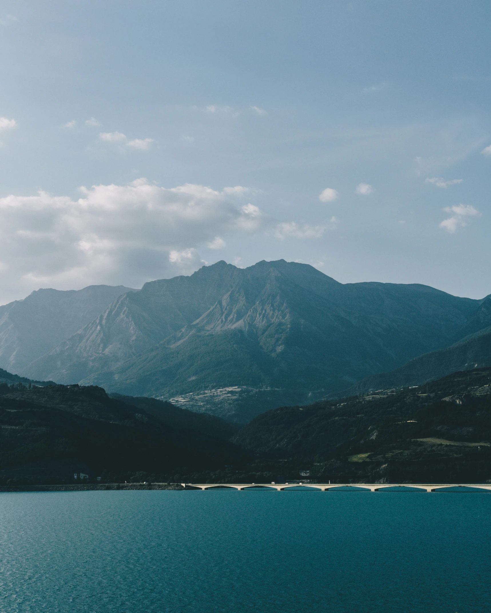 a boat sits on a lake in front of some mountains