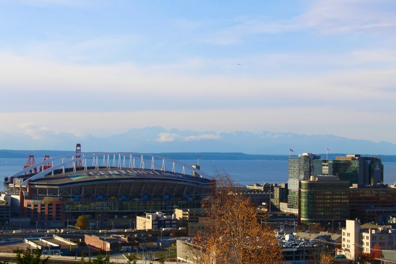 a very tall building with a big dome and a body of water in the distance