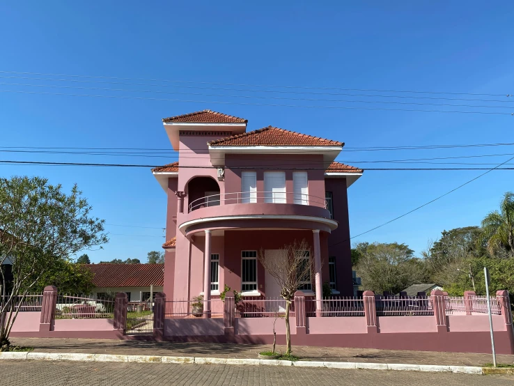 an old building that is painted pink in the day