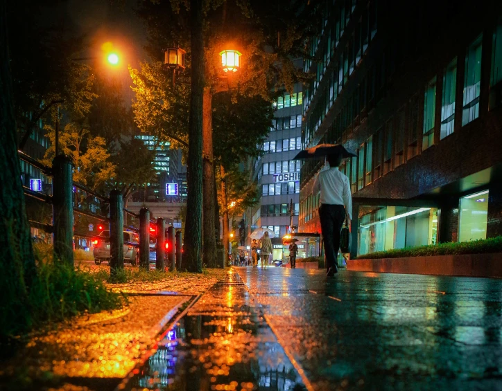 two people walking on the street with an umbrella