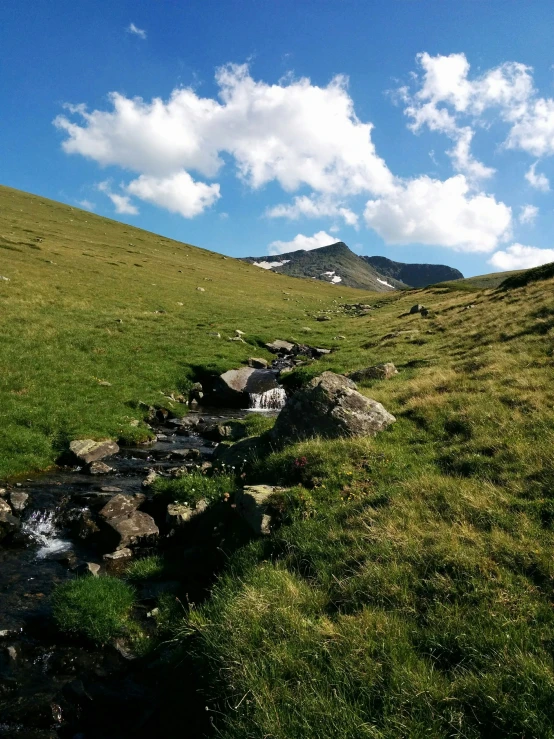 water flowing down the hill with rocks in it