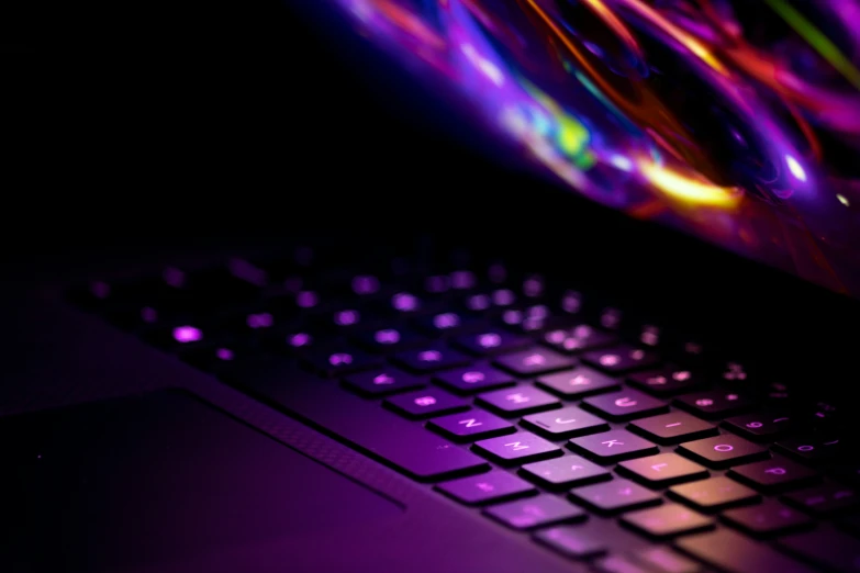 a computer keyboard lit up with colorful lights