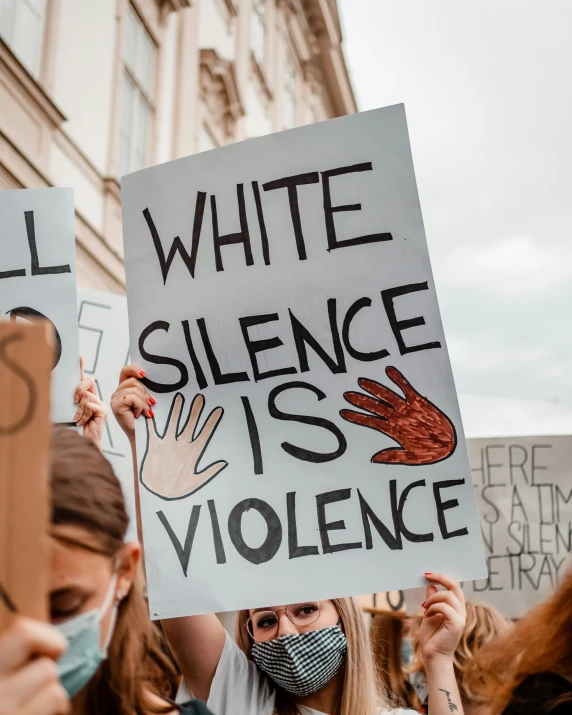 a protest holding signs in front of a building