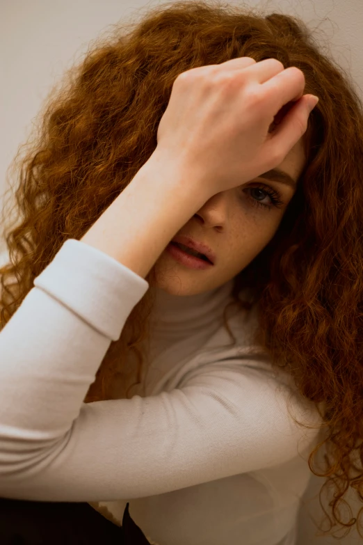 the girl with curly red hair looks serious and serious