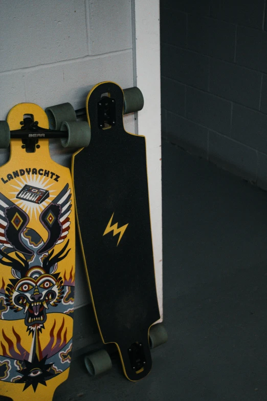 a skateboard on a wall and a skate board sitting up against the wall