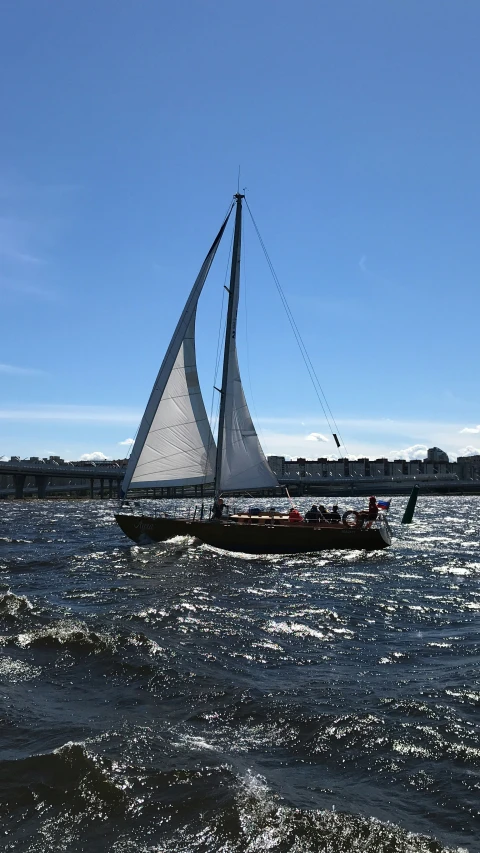 a sailboat on the water near the beach