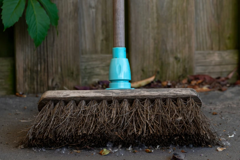 a small brush laying on top of a concrete ground