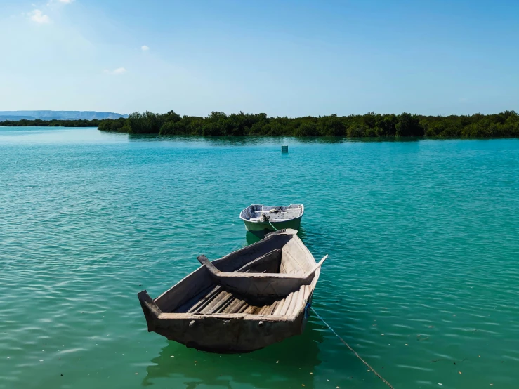 two boats tied to each other in a body of water