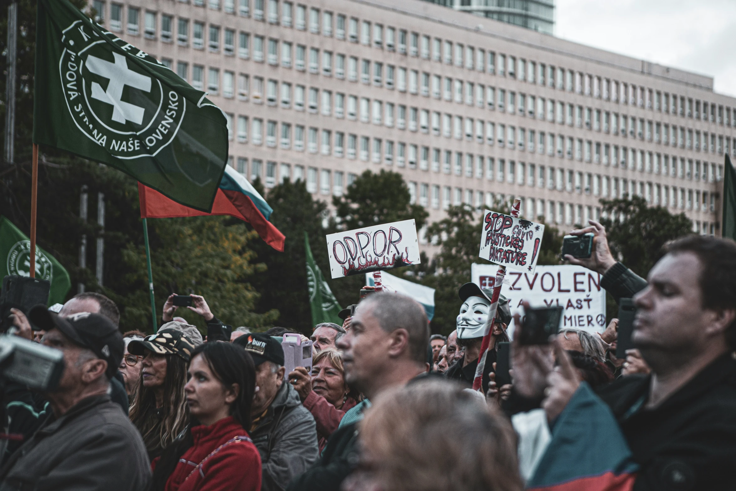 people are protesting in a large public rally