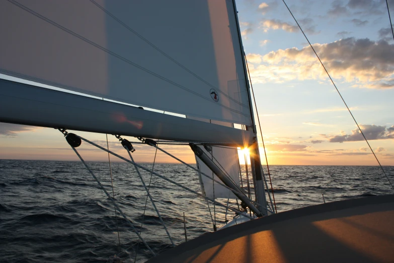 sun is setting while sailing on a body of water